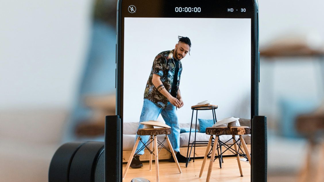 A man recording himself using his phone