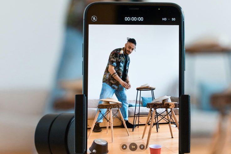 A man recording himself using his phone