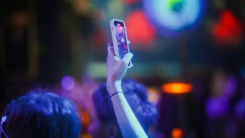 a person taking a picture with a cell phone