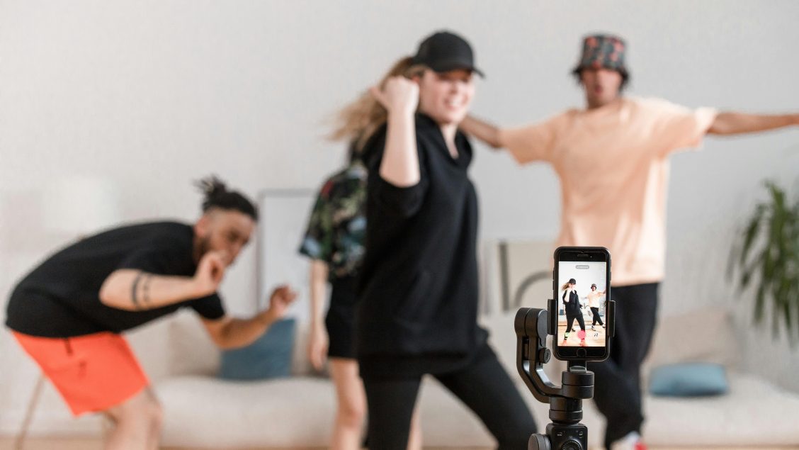 People dancing in front of a smartphone