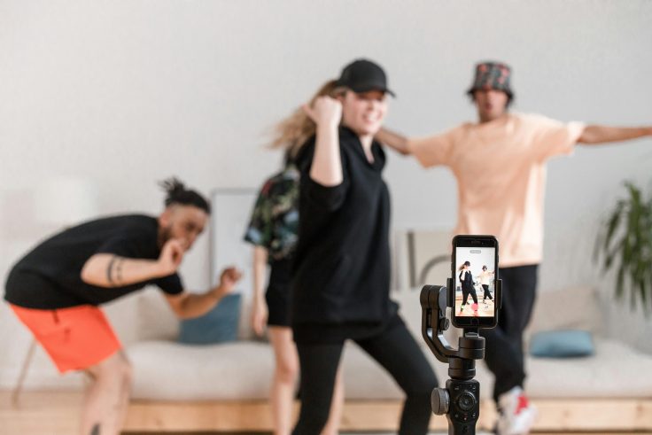 People dancing in front of a smartphone